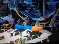 Cam guides a big group in meditation by the hammock.