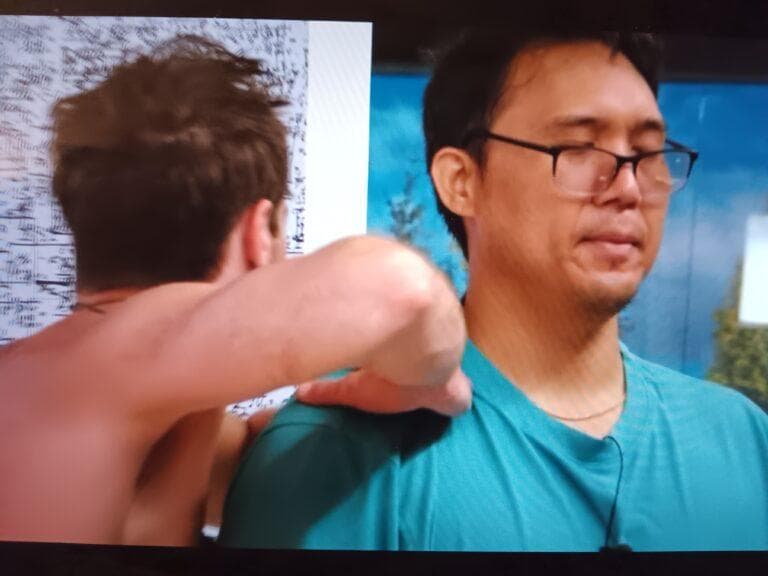 Tucker massages Kimo’s shoulders.